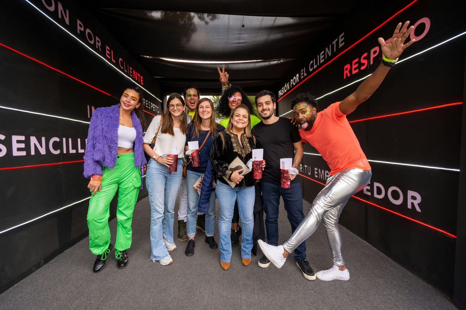 Vibrant group of guests posing in activation tunnel